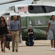 US President Barack Obama, First Lady Michelle Obama and daughters Malia and Sasha walk to board Air Force One at Cape Cod Air Force Station in Massachusetts on August 21, 2016 as they depart for Washington after a two-week holiday at nearby Martha’s Vineyard.